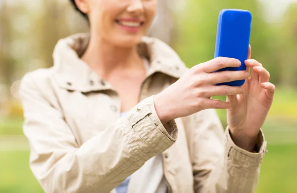 Close up of woman taking picture with smartphone — ストック写真