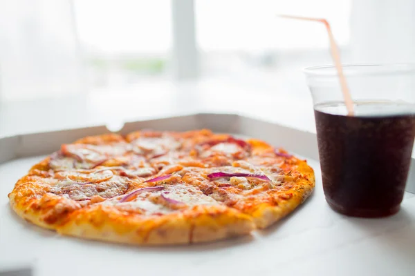 Close up of pizza with coca cola on table — Stock Photo, Image