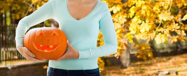 Close up of woman with carved halloween pumpkin — Stock Photo, Image