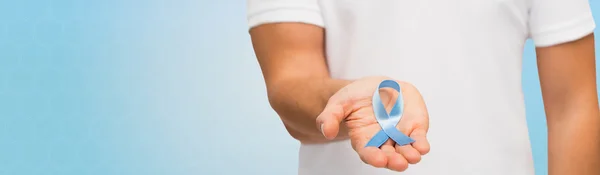 Hand with blue prostate cancer awareness ribbon — Stock Photo, Image