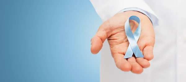 Doctor hand with prostate cancer awareness ribbon — Zdjęcie stockowe