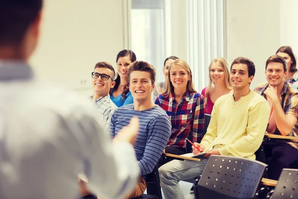 Group of students and teacher with notebook — Stock Photo, Image