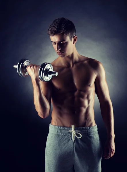 Young man with dumbbell — Stock Photo, Image