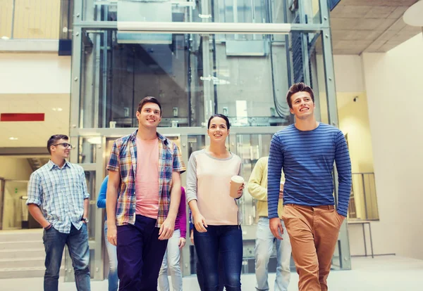 Group of smiling students with paper coffee cups — Stock Photo, Image