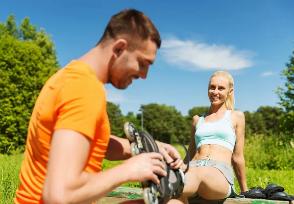 Happy couple with rollerblades outdoors — Stock Photo, Image