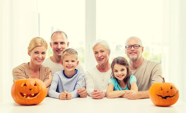 Familia feliz sentado con calabazas en casa — Foto de Stock