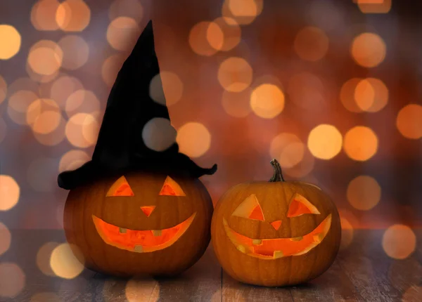 Close up of pumpkins over holiday lights background — Stock Photo, Image