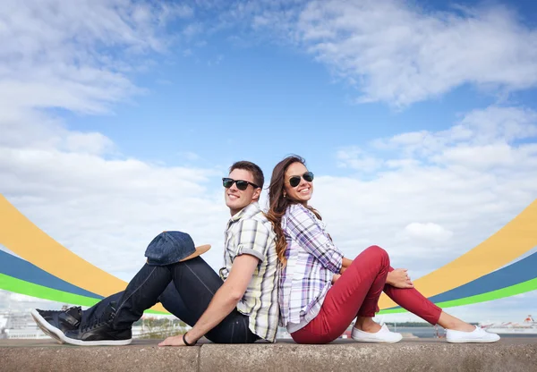 Teenagers sitting back to back — Stock Photo, Image