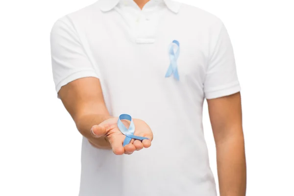 Hand with blue prostate cancer awareness ribbon — Stock Photo, Image