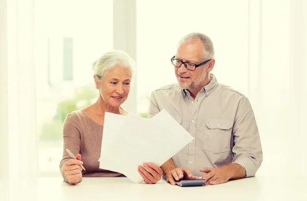 Senior couple with papers and calculator at home Stock Photo