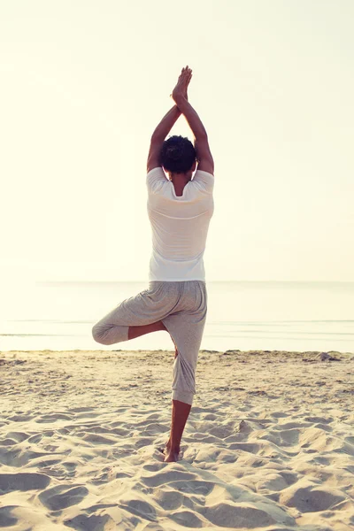 Man making yoga exercises outdoors from back — Stock Photo, Image