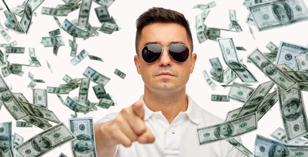 Man pointing on you with falling dollar money — Stock Photo, Image