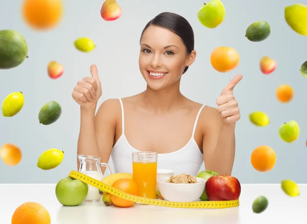 Mujer feliz con comida saludable mostrando los pulgares hacia arriba —  Fotos de Stock