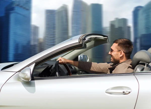 Happy man driving cabriolet car outdoors — Stock Photo, Image
