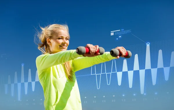 Sporty woman with light dumbbells outdoors — Stock Photo, Image