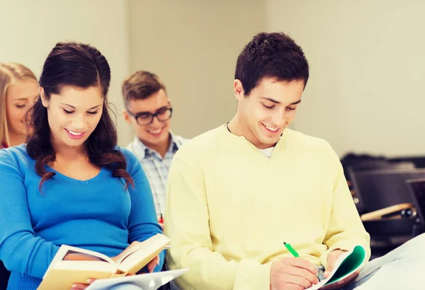 Group of smiling students with notebooks — Stock Photo, Image