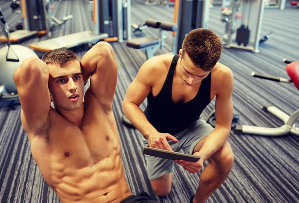 Mężczyzn wyginanie mięśni brzucha w siłowni — Zdjęcie stockowe