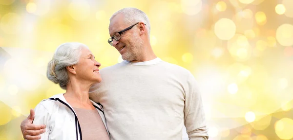 Happy senior couple over holiday lights background — ストック写真