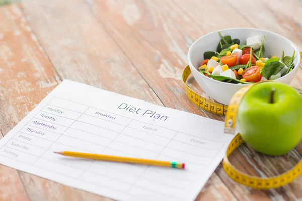 Close up of diet plan and food on table — Stock Photo, Image