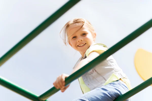 Happy little girl climbing on children playground — Stock Photo, Image
