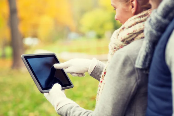 Couple hands in gloves with tablet pc outdoors — Stok fotoğraf