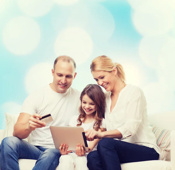 Happy family with tablet pc and credit card — Stock Photo, Image