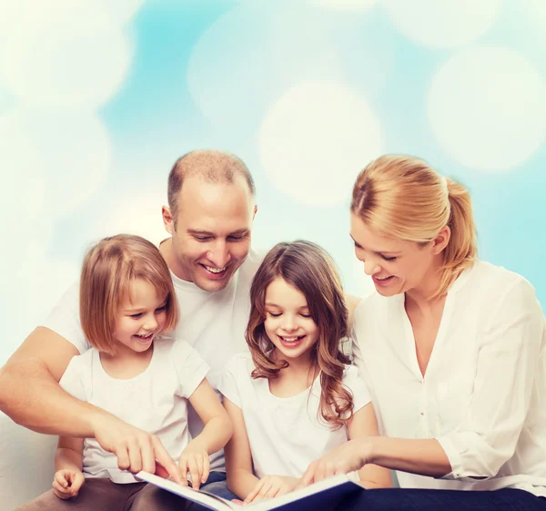 Happy family with book at home — Stock Photo, Image