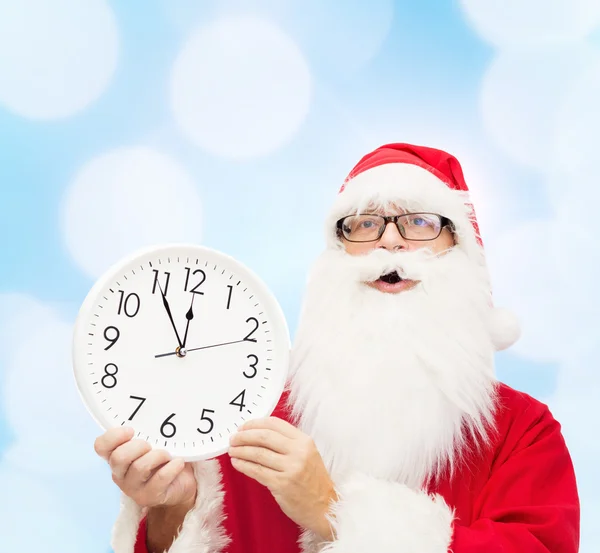 Man in costume of santa claus with clock — Stock Photo, Image