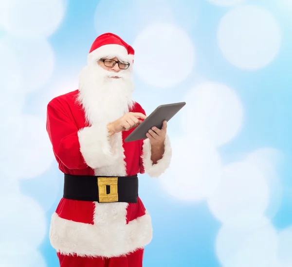 Man in costume of santa claus with tablet pc — Stock Photo, Image