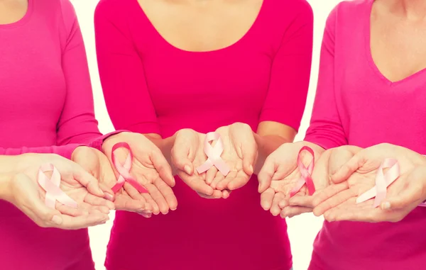 Close up of women with cancer awareness ribbons — Stock Photo, Image