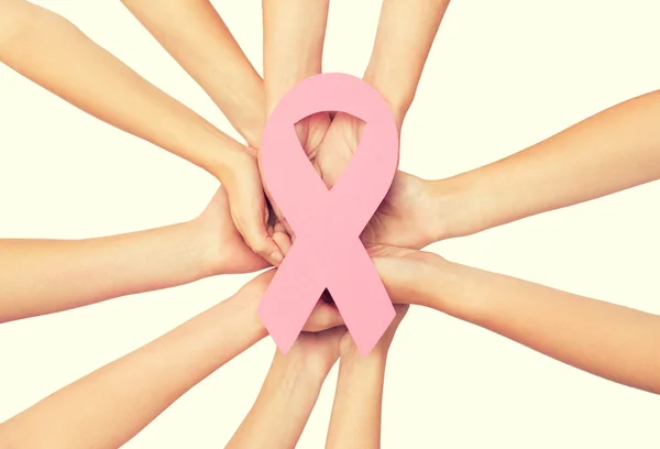 Close up of hands with cancer awareness symbol — Stock Photo, Image