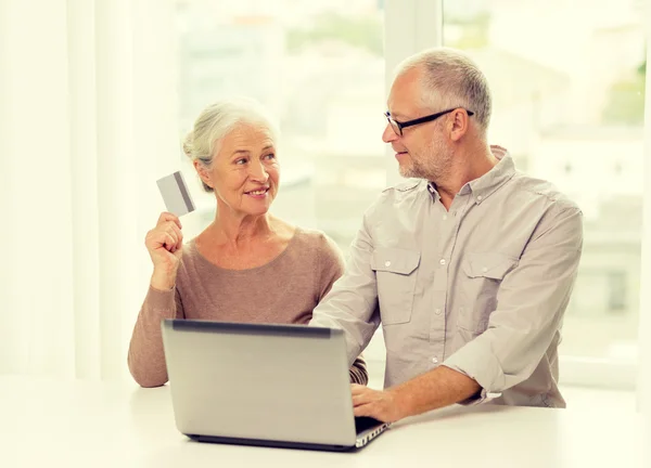 Gelukkige senior paar met laptop en credit card — Stockfoto