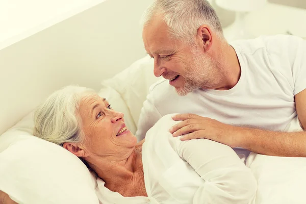 Happy senior coupler lying in bad at home — Stock Photo, Image