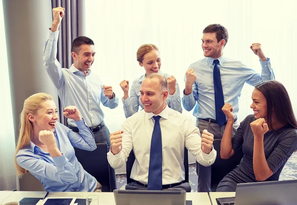 business people celebrating victory in office