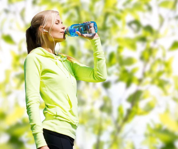 Mujer beber agua después de hacer deportes al aire libre — Foto de Stock