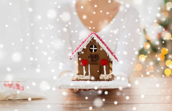 Close up of woman showing gingerbread house — Stock Photo, Image