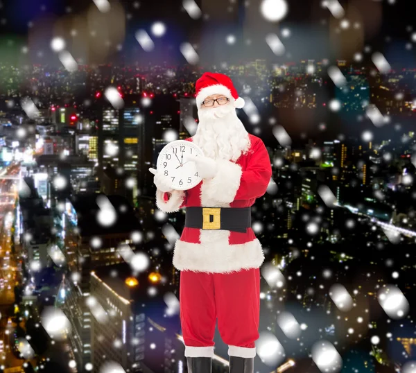 Man in costume of santa claus with clock — Stock Photo, Image