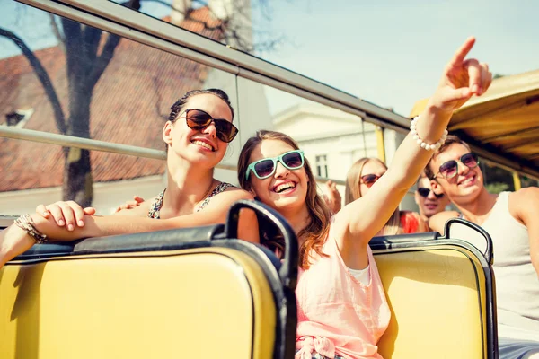 Group of smiling friends traveling by tour bus — Stock Photo, Image