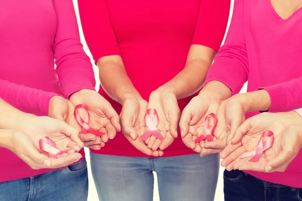 Close up of women with cancer awareness ribbons — Stock Photo, Image