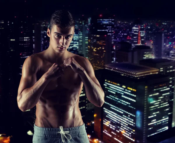 Young man in fighting or boxing position — Stock Photo, Image