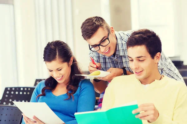 Group of smiling students with notebooks — Stock Photo, Image