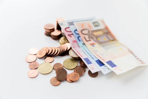 Close up of euro paper money and coins on table — Stock Photo, Image