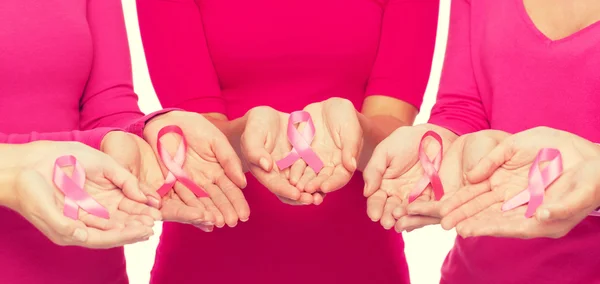 Close up of women with cancer awareness ribbons — Stock Photo, Image