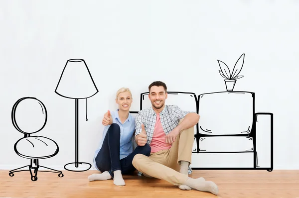 Glückliches Paar zeigt Daumen hoch im neuen Zuhause — Stockfoto