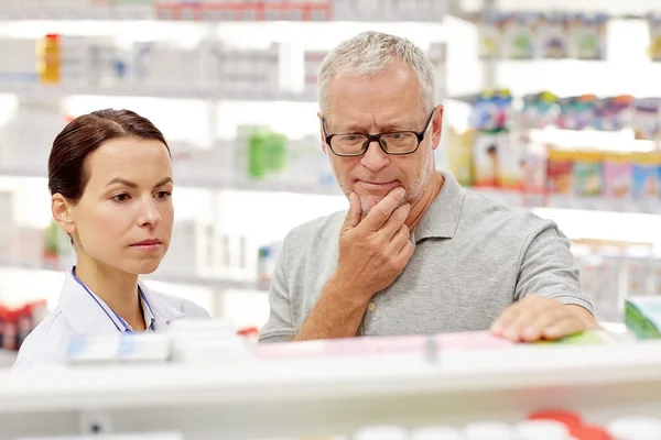 Apotheker zeigt Senior in Apotheke Medikament Stockbild