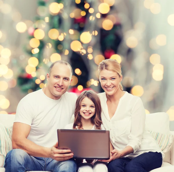 Smiling family with laptop — Stok fotoğraf