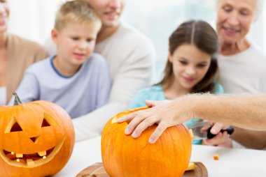 family making lantern of pumpkins for helloween clipart