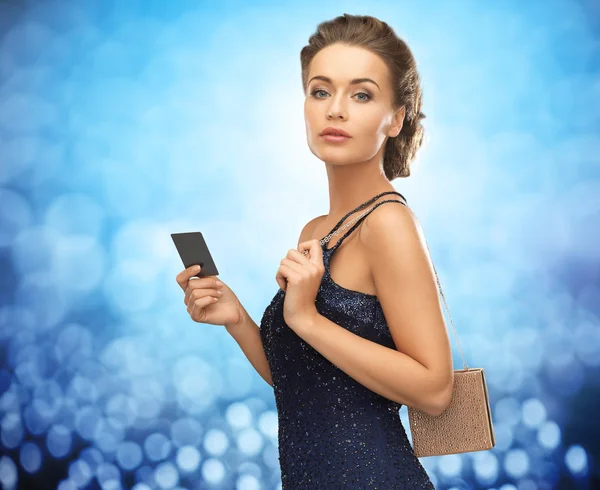 Beautiful woman in evening dress with card — Stock Photo, Image