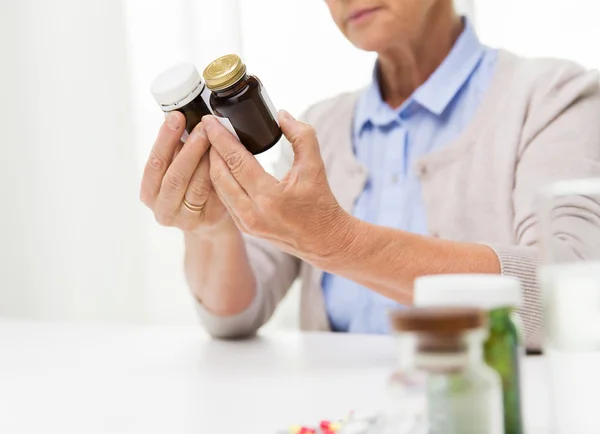 Senior woman with medicine jars — Stock Photo, Image