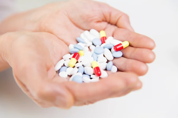 Close up of senior woman hands with pills — Stock Photo, Image